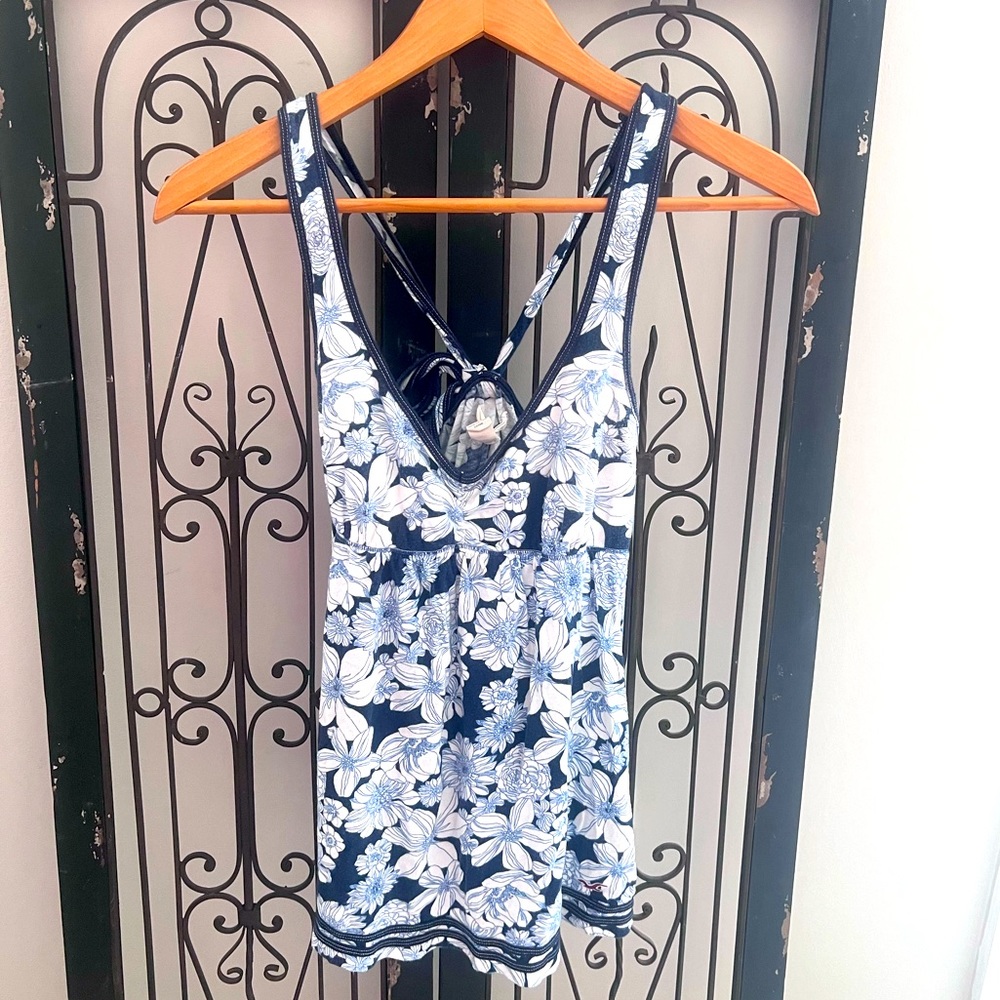 Hollister floral tank top with tied back and blue trim.